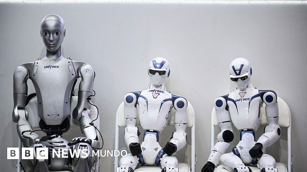 Three grey and white humanoid robots bearing the Unitree brand standing together against a light grey background.