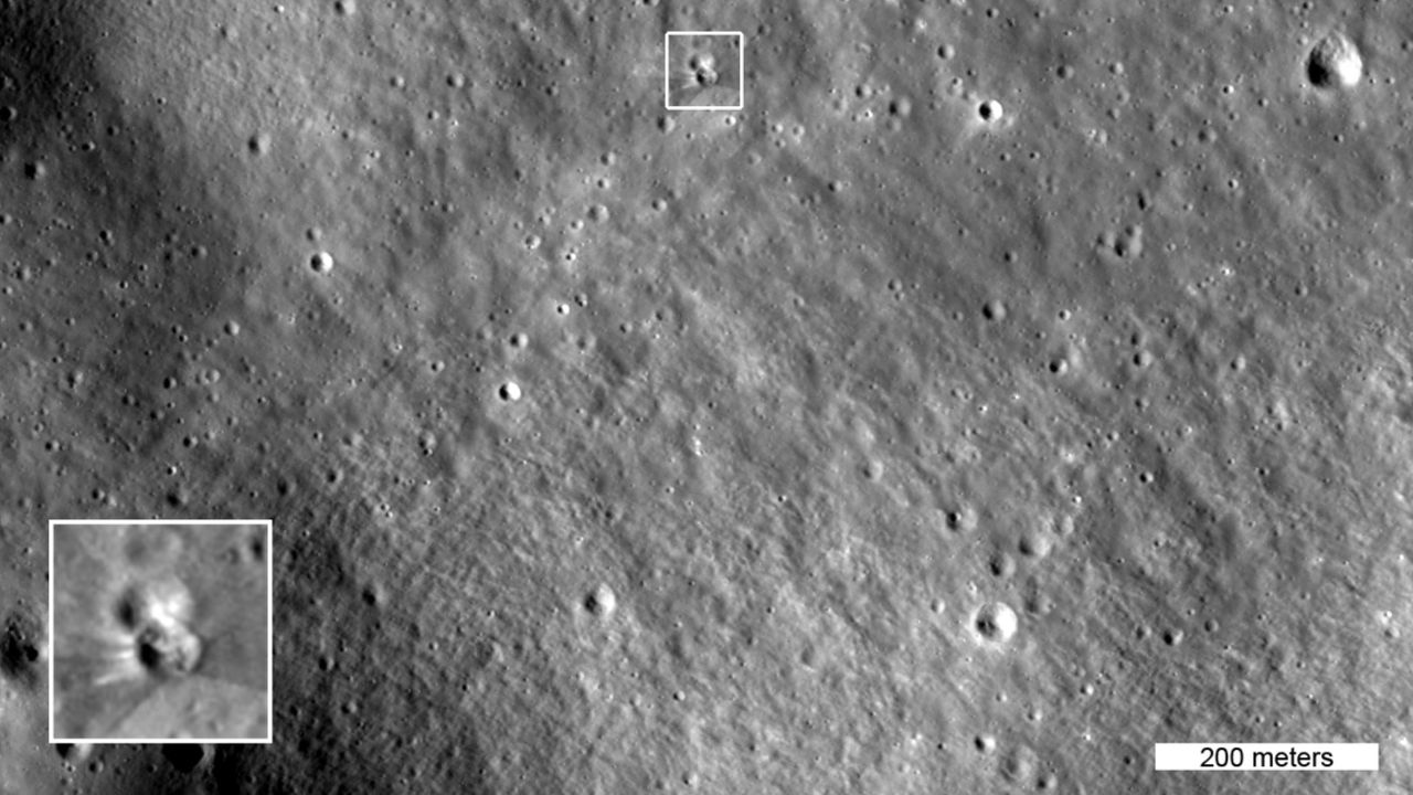 Greyscale satellite image of the lunar surface showing multiple small impact craters, with a white box highlighting one larger particular crater and a close-up in the lower left corner revealing details of the impacted crater.