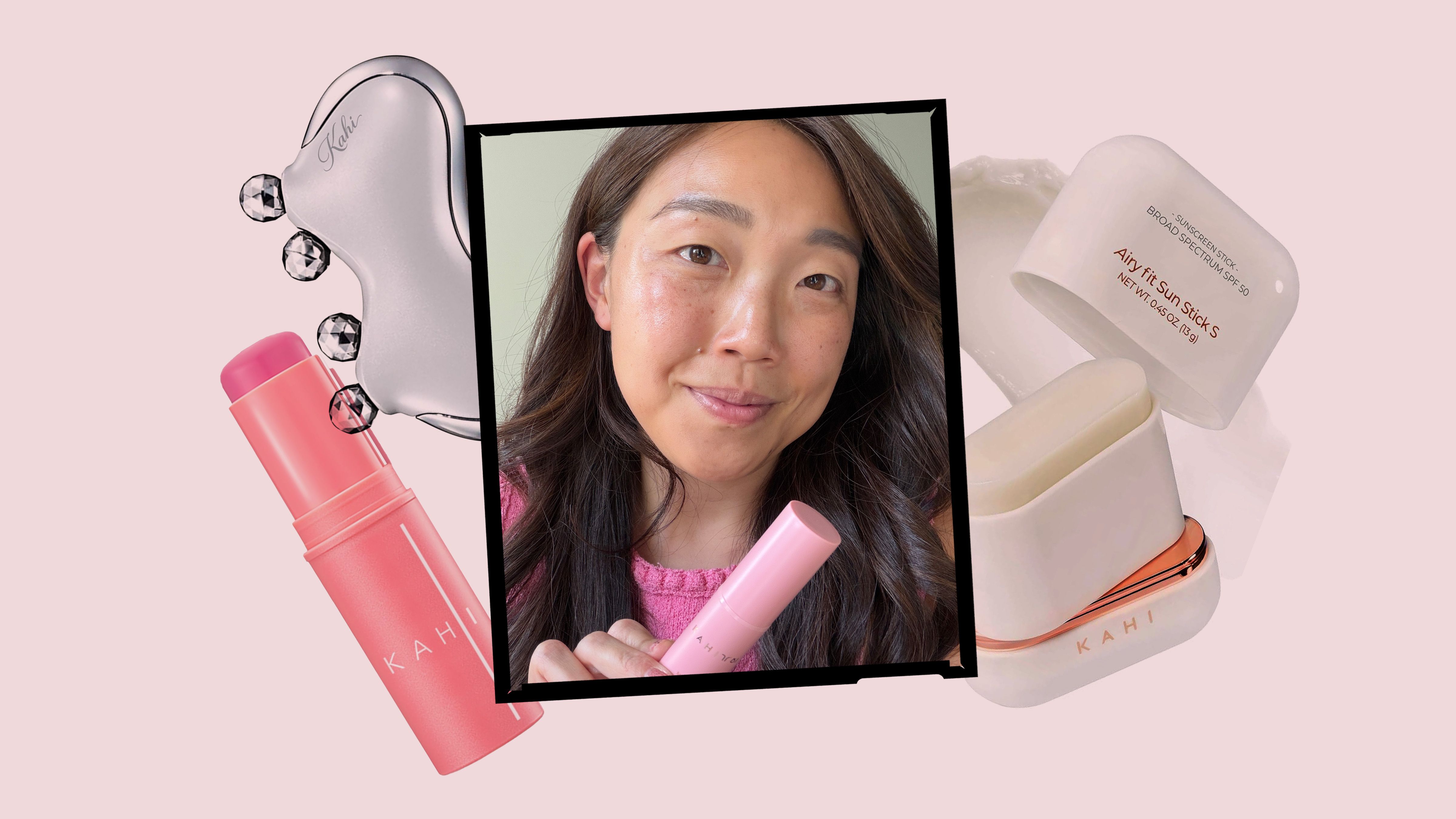 Una mujer asiática sostiene varios productos de skincare de la marca Kahi sobre un fondo rosa, incluyendo una barra de labios rosa, un dispositivo facial y botellas de protector solar.