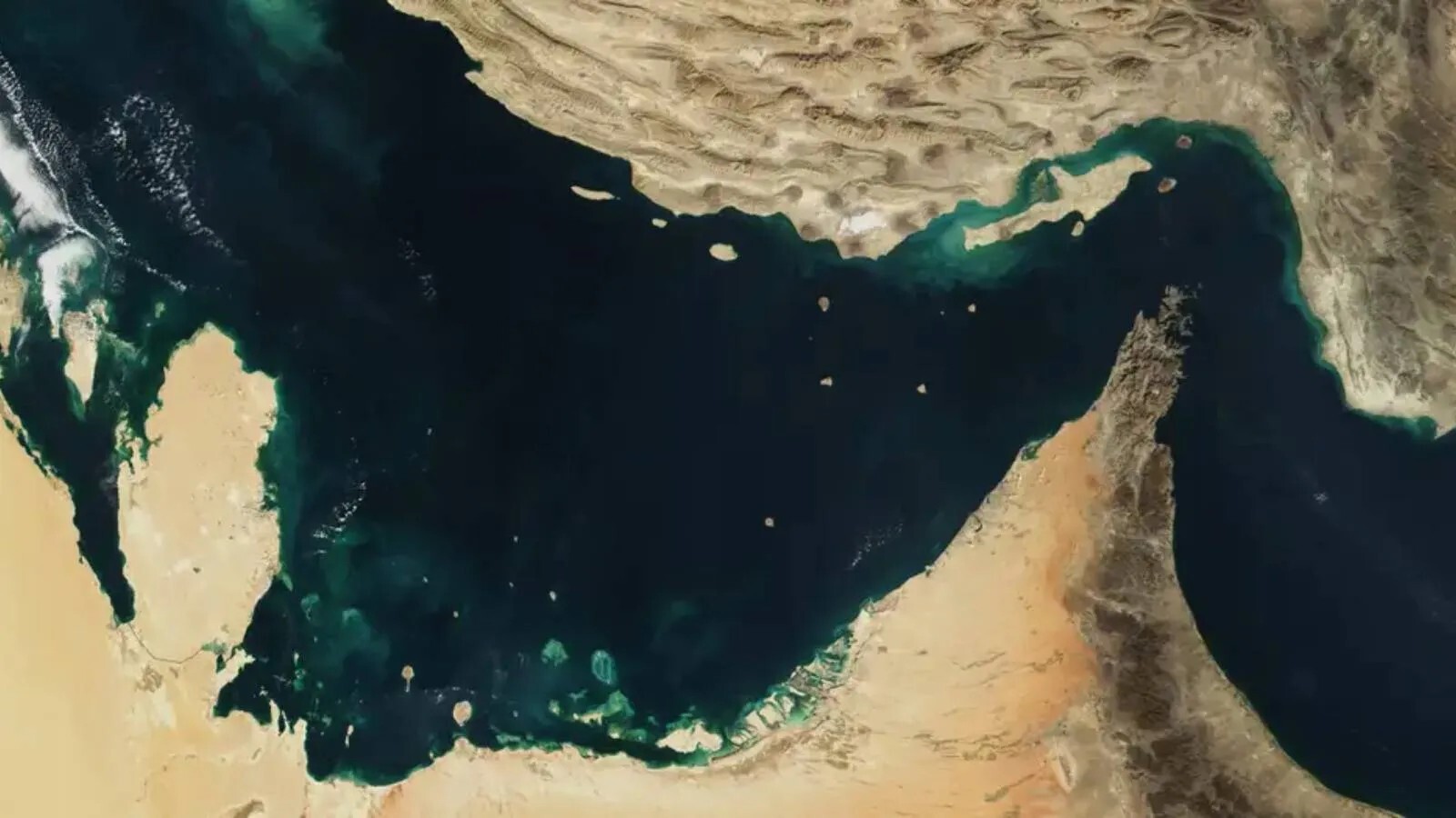 Satellite view of the Persian Gulf showing the Strait of Hormuz between Iran and Oman, surrounded by the deserts of Saudi Arabia and Iran.