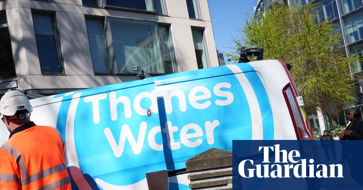 A Thames Water service vehicle parked on a city street with modern buildings in the background.