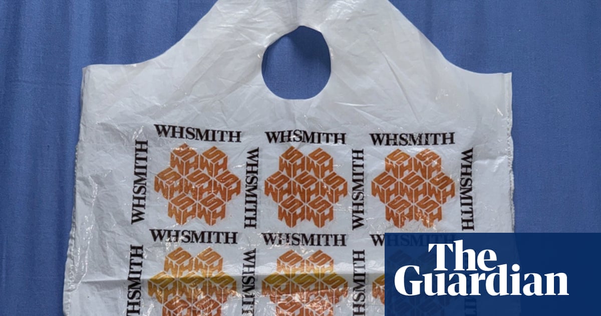 A white plastic carrier bag with a repeating geometric orange logo pattern and the text "WHSMITH" printed across it, displayed against a blue background.